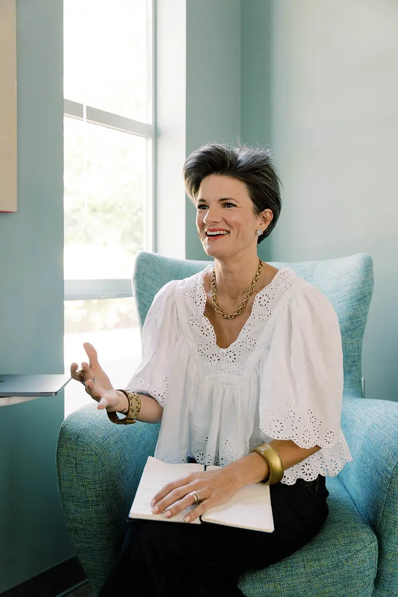 Woman in therapy session, smiling.